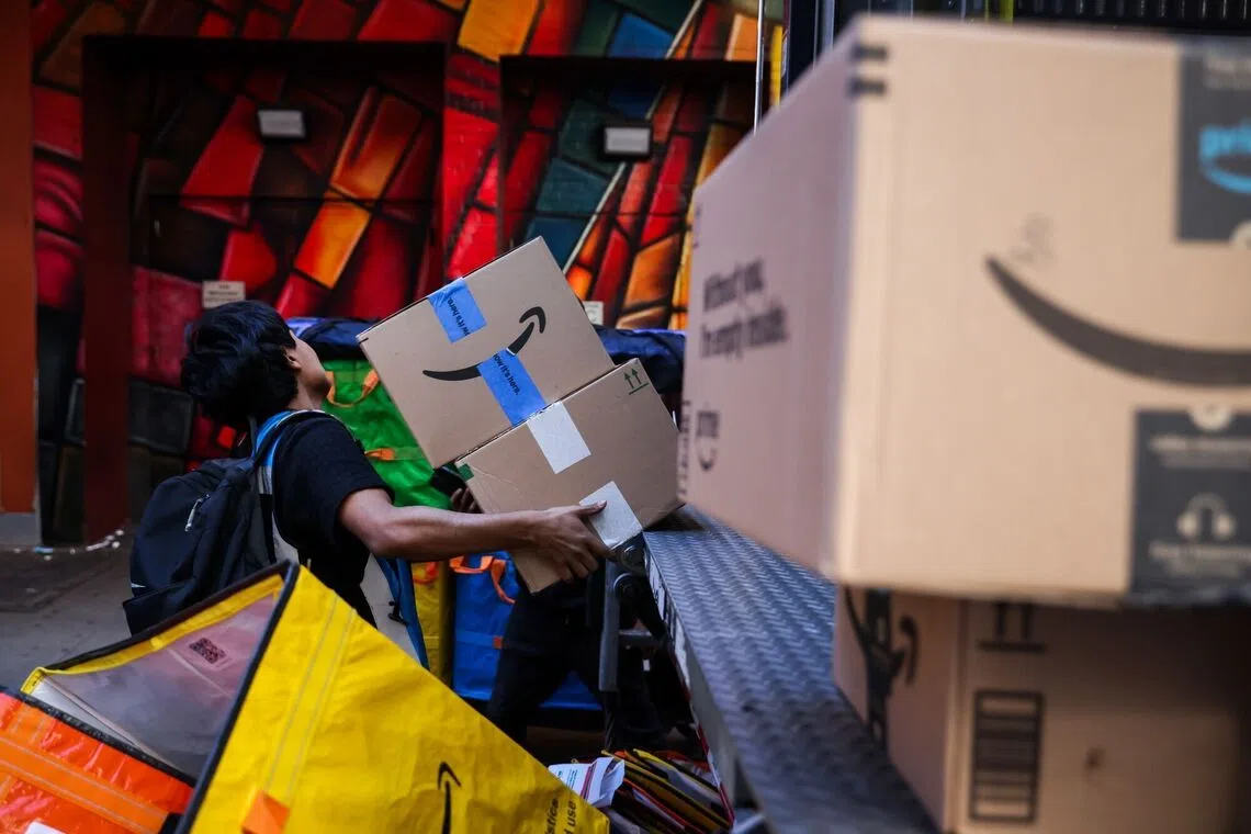A worker in New York unloading packages from online agent Amazon, which has blocked agentic shopping.