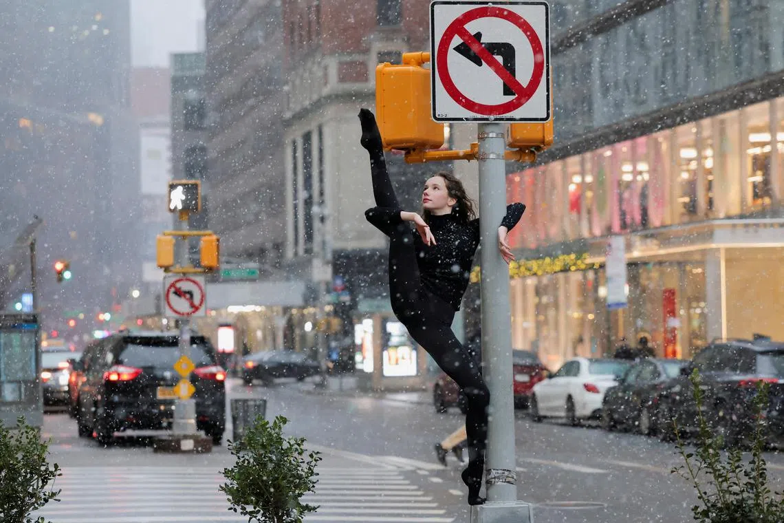 Dancer Skye Madison Murphy poses for a photographer as snow falls in New York City on Jan 6. 