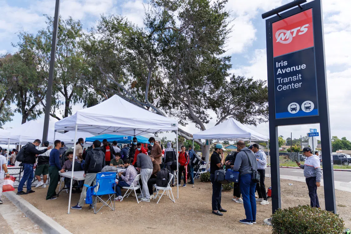 Migrants, who crossed the U.S.-Mexico border and were detained and released by U.S. Customs and Border Protection, gather at a transit station as they plan to travel across the country from the San Ysidro neighborhood of San Diego, California, U.S., September 20, 2023. REUTERS/Mike Blake