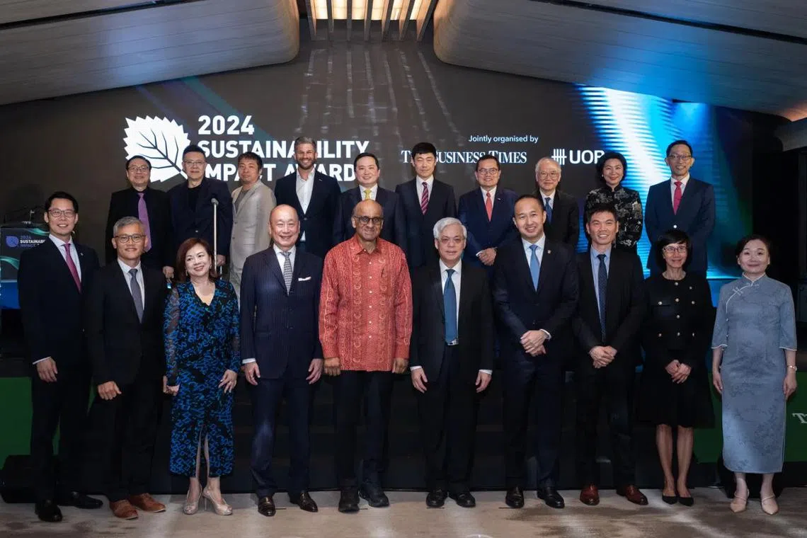 Front row: President Tharman Shanmugaratnam (fifth from left), UOB chief executive Wee Ee Cheong (fourth from left) and BT editor Chen Huifen (first from right), with winners of the Sustainability Impact Awards 2024. 