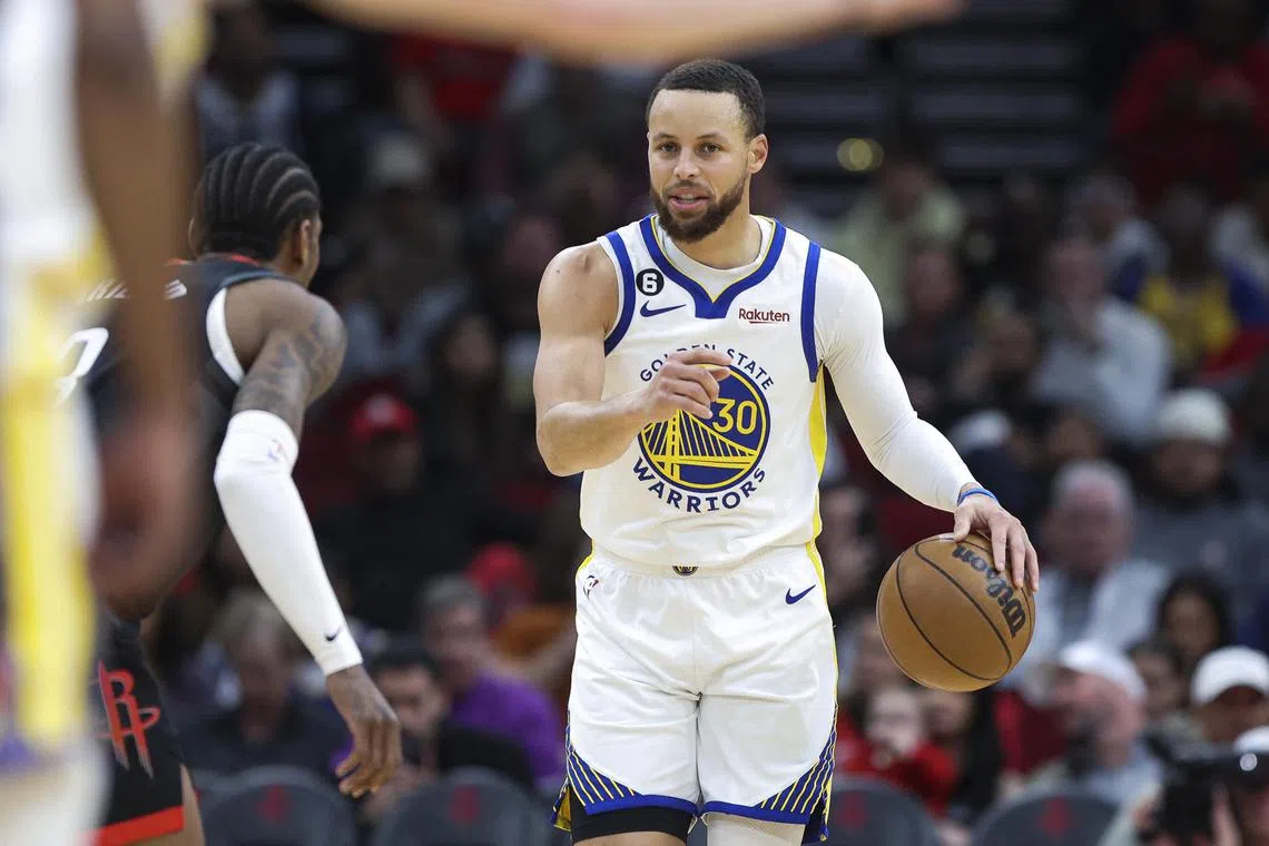 Golden State Warriors guard Stephen Curry controlling the ball during the first quarter against the Houston Rockets at Toyota Centre.