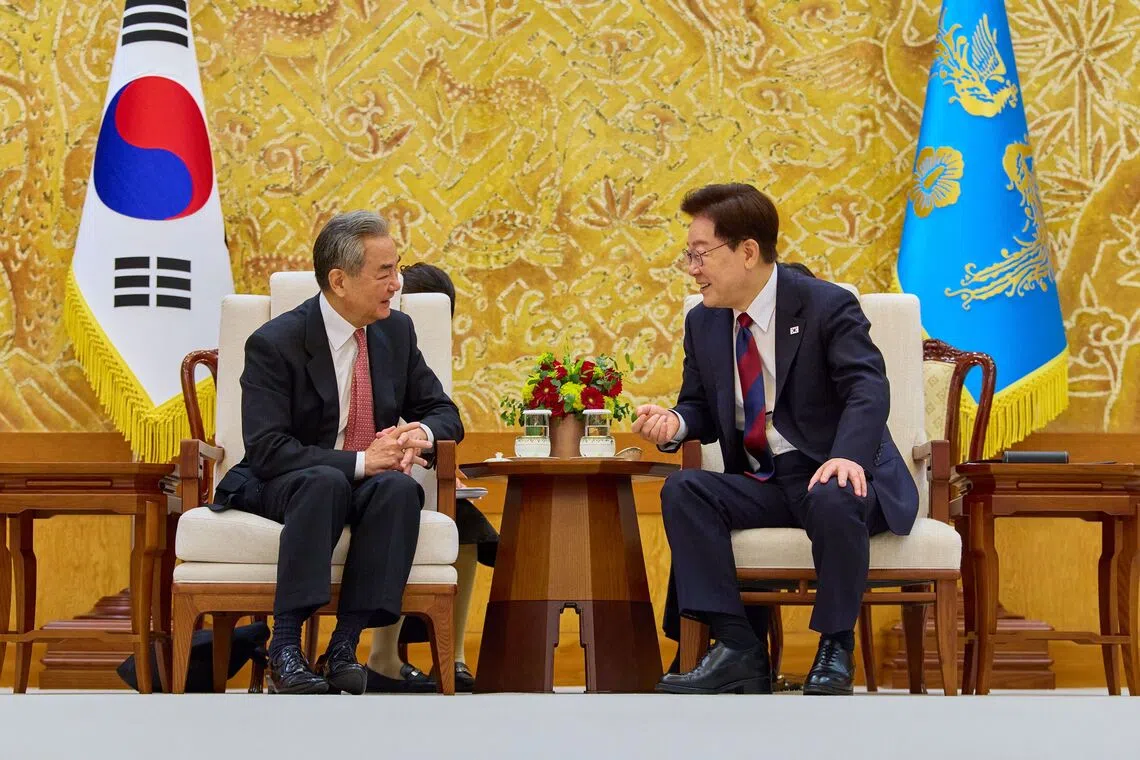 South Korean President Lee Jae Myung (right) meeting with Chinese Foreign Minister Wang Yi at the presidential office in Seoul, South Korea, on Aug 20.