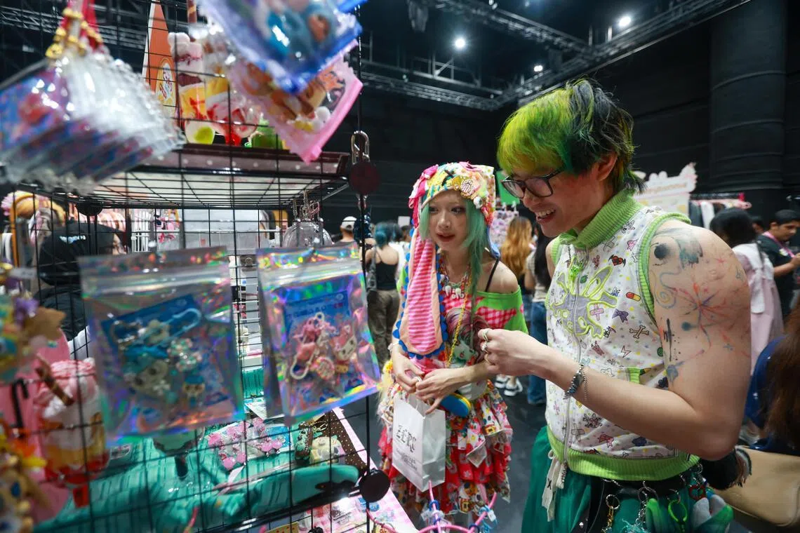 Visitors looking through brightly coloured trinkets at a booth in Konbini on Jun 6.