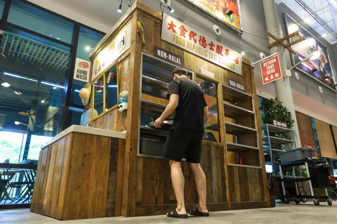 The tray return station is designed to mimic a taxi-service phone booth.