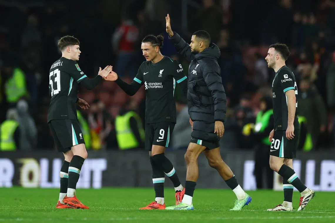 Liverpool's James McConnell, Darwin Nunez, Diogo Jota and Cody Gakpo celebrate after the match.