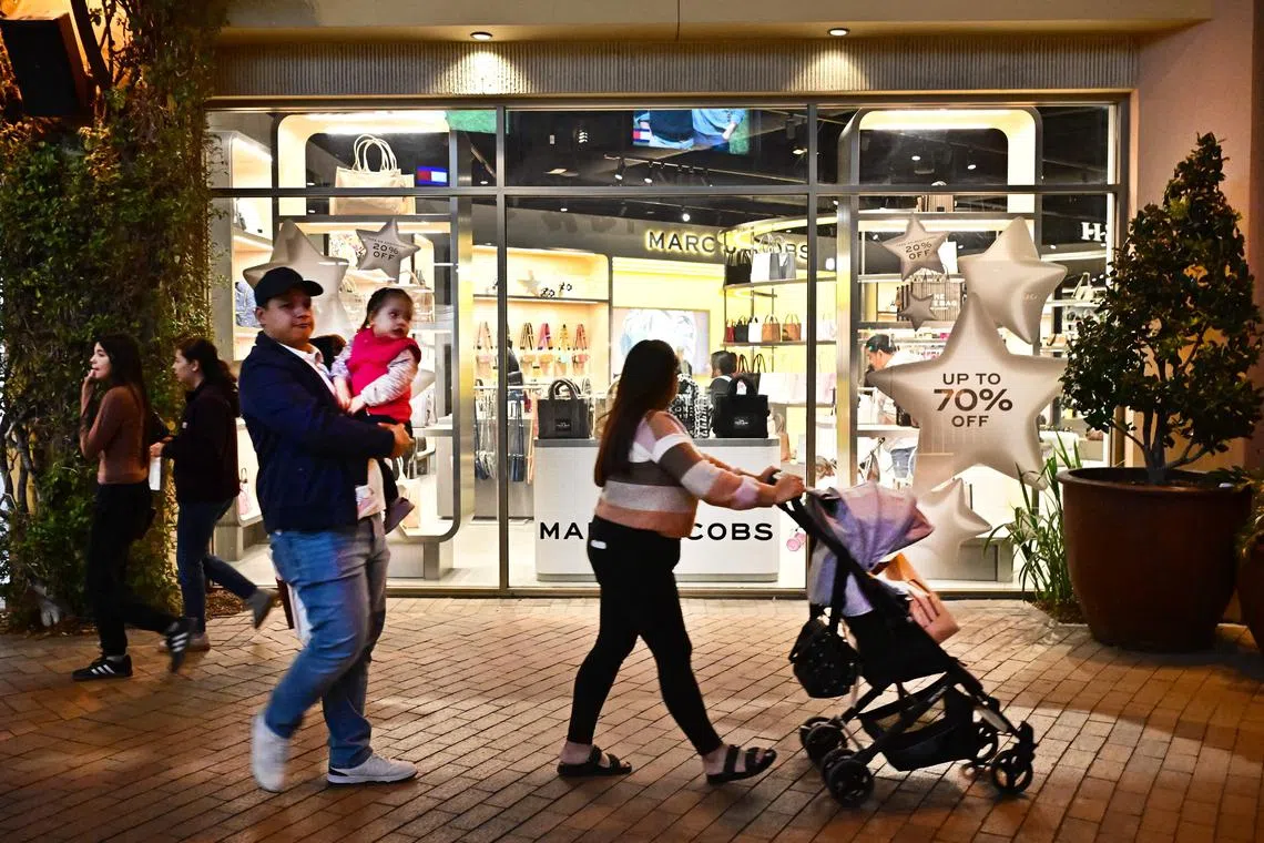 Consumers shop at an Outlet mall in Los Angeles, California on November 8, 2024. USPresident-elect Donald Trump won the November 5 presidential election thanks to voter response to his agenda of cutting taxes and regulations and raising tariffs, but economists say his proposed radical new tariff policies will hurt the US economy and fuel inflation. (Photo by Frederic J. BROWN / AFP)