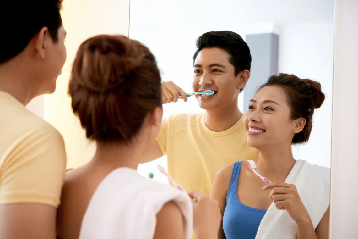 Couple brushing teeth