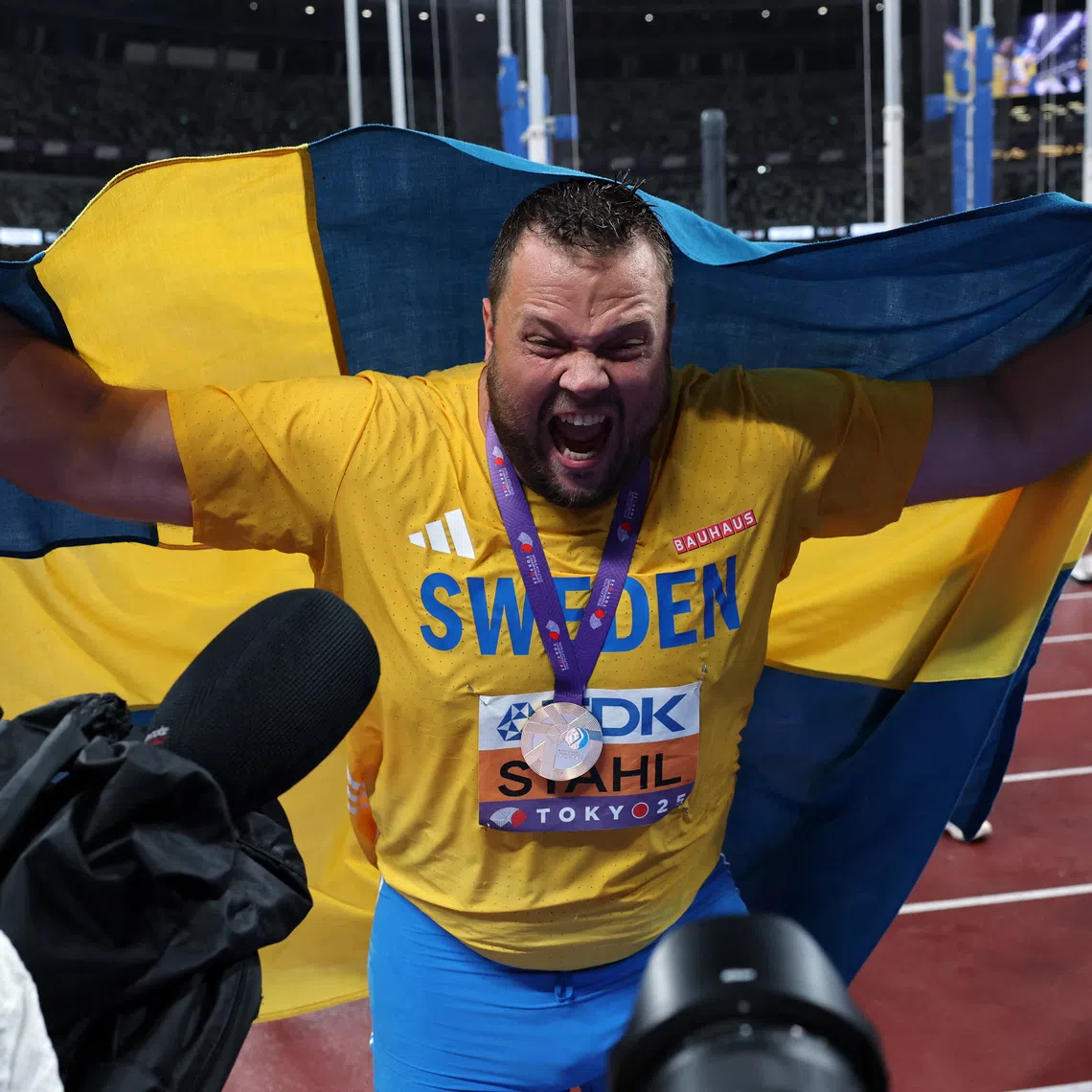 Sweden's Daniel Stahl celebrates with his medal and national flag after winning gold.