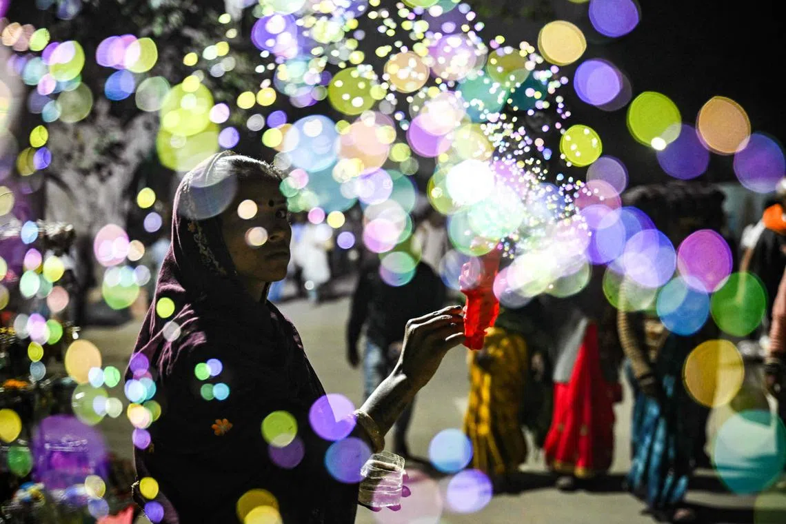 A street vendor sells soap-bubble-making toys during the Maha Kumbh Mela festival in Prayagraj, India on Feb 2, 2025. 