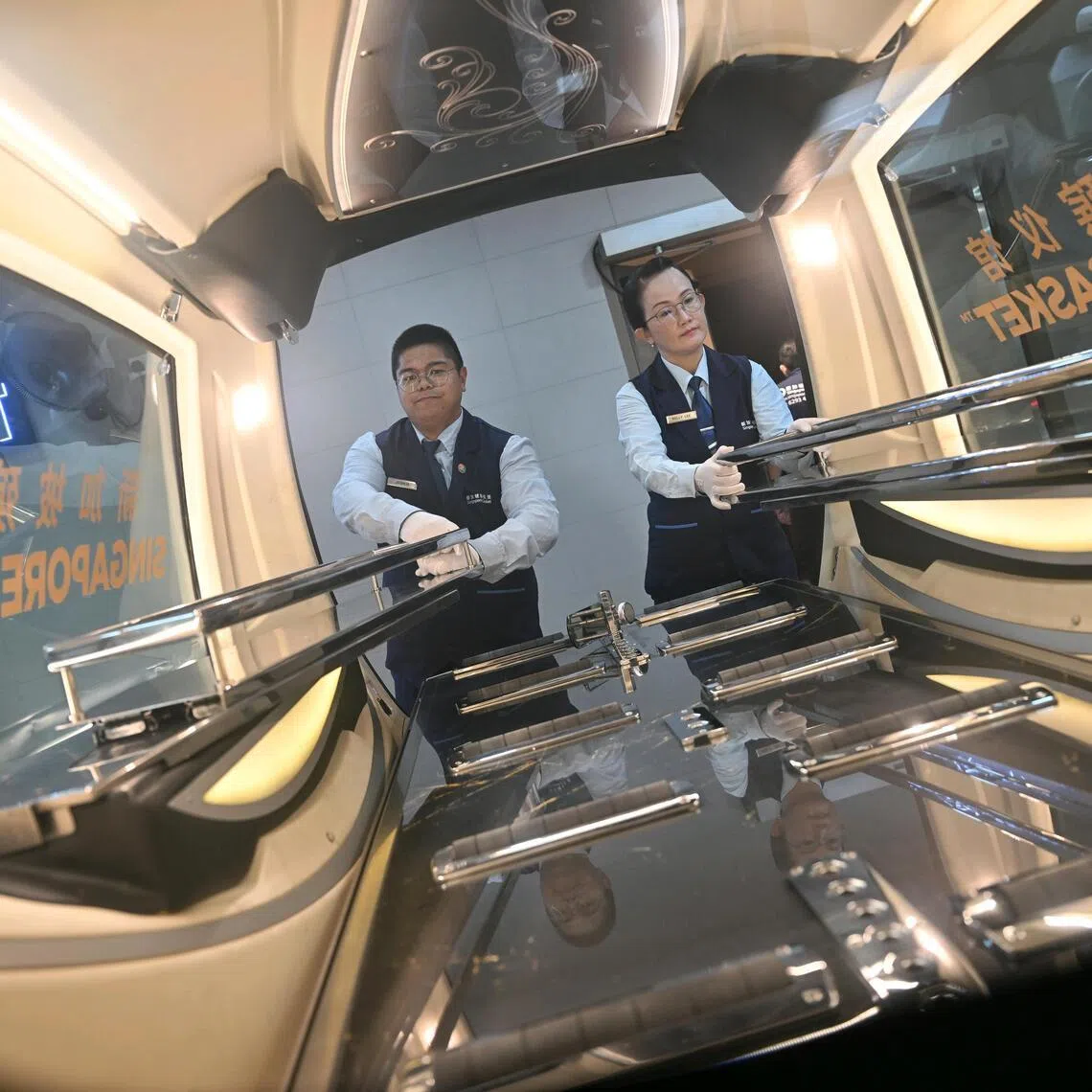 Singapore Casket staff unloading a hearse.