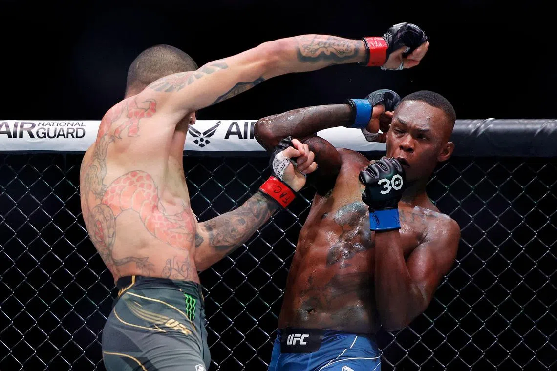 Alex Pereira (left) of Brazil exchanging strikes with Nigerian-born New Zealander Israel Adesanya in their middleweight title bout during UFC 287 at Kaseya Centre on Saturday.