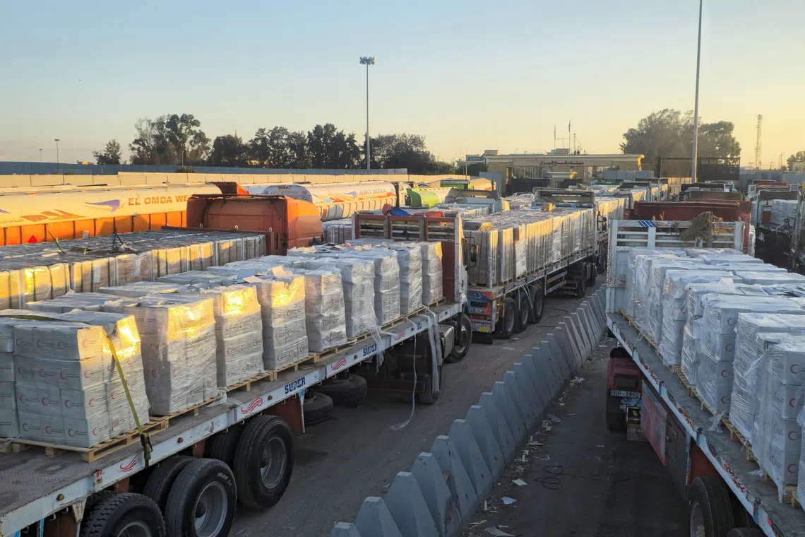 Trucks carrying humanitarian aid line up at the Rafah border on the Egypt side and enter the crossing into the Gaza Strip, after a ceasefire between Israel and Hamas in Gaza went into effect, in Rafah, Egypt, October 16, 2025. REUTERS/Stringer