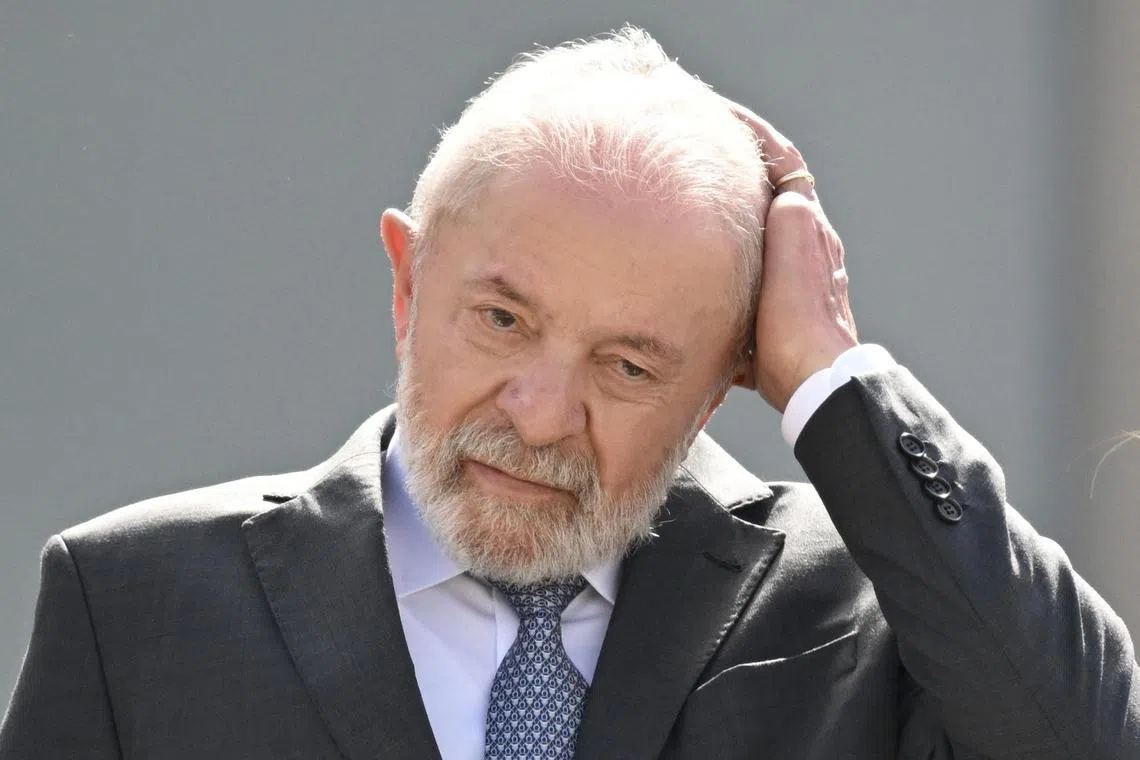 (FILES) Brazil's President Luiz Inacio Lula da Silva gestures during a military parade welcoming Angola's President Joao Lourenco at Planalto Palace in Brasilia, on May 23, 2025. Brazilian President Luiz Inácio Lula da Silva suffered from vertigo and was diagnosed on May 26, 2025, with “labyrinthitis,” an ear condition, the government reported, in a new health problem for the almost octogenarian president. (Photo by EVARISTO SA / AFP)