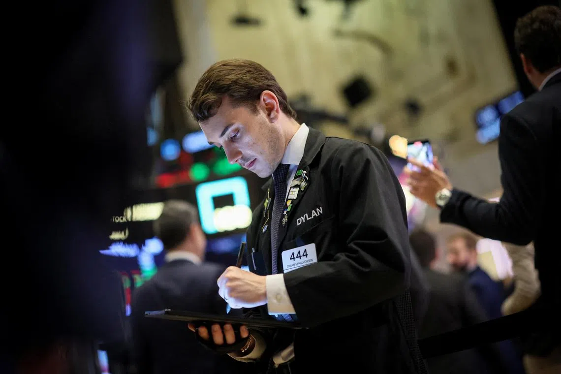 A trader works on the floor at the New York Stock Exchange, in New York City.    