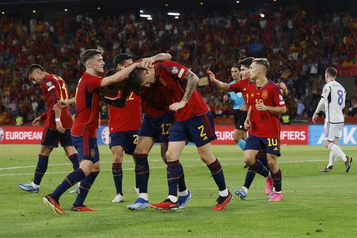 Soccer Football - Euro 2024 Qualifier - Group A - Spain v Scotland - Estadio de La Cartuja, Seville, Spain - October 12, 2023 Spain's Oihan Sancet celebrates with teammates after Scotland's Ryan Porteous scores an own goal and Spain's second REUTERS/Marcelo Del Pozo