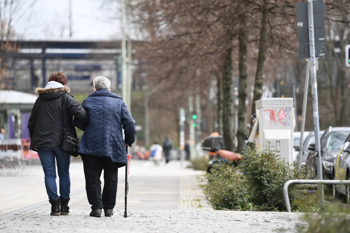 Two elderly persons walk in Berlin, Germany, March 19, 2020. REUTERS/Annegret Hilse