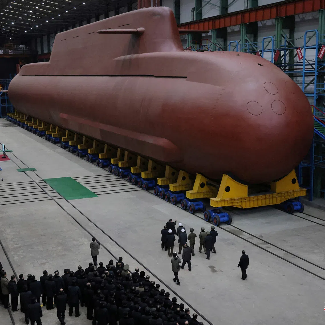 North Korean leader Kim Jong Un visits the construction site of an 8,700-ton nuclear-powered submarine capable of launching surface-to-air missiles.