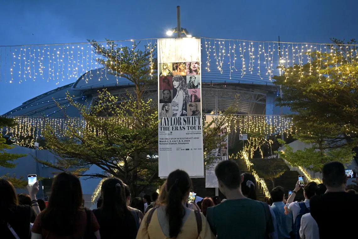 Fans without any tickets enjoying the Taylor Swift eras concert outside the National Stadium.