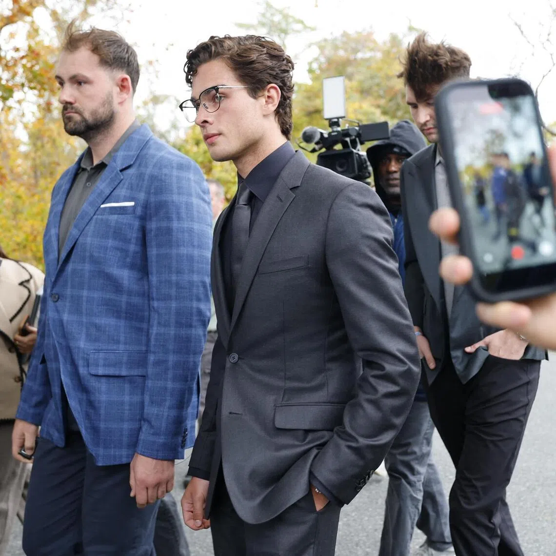 Defendant Braden Eric Peters - known online as Clavicular (centre right) - leaving court on Oct 22, in Orleans, Massachusetts.