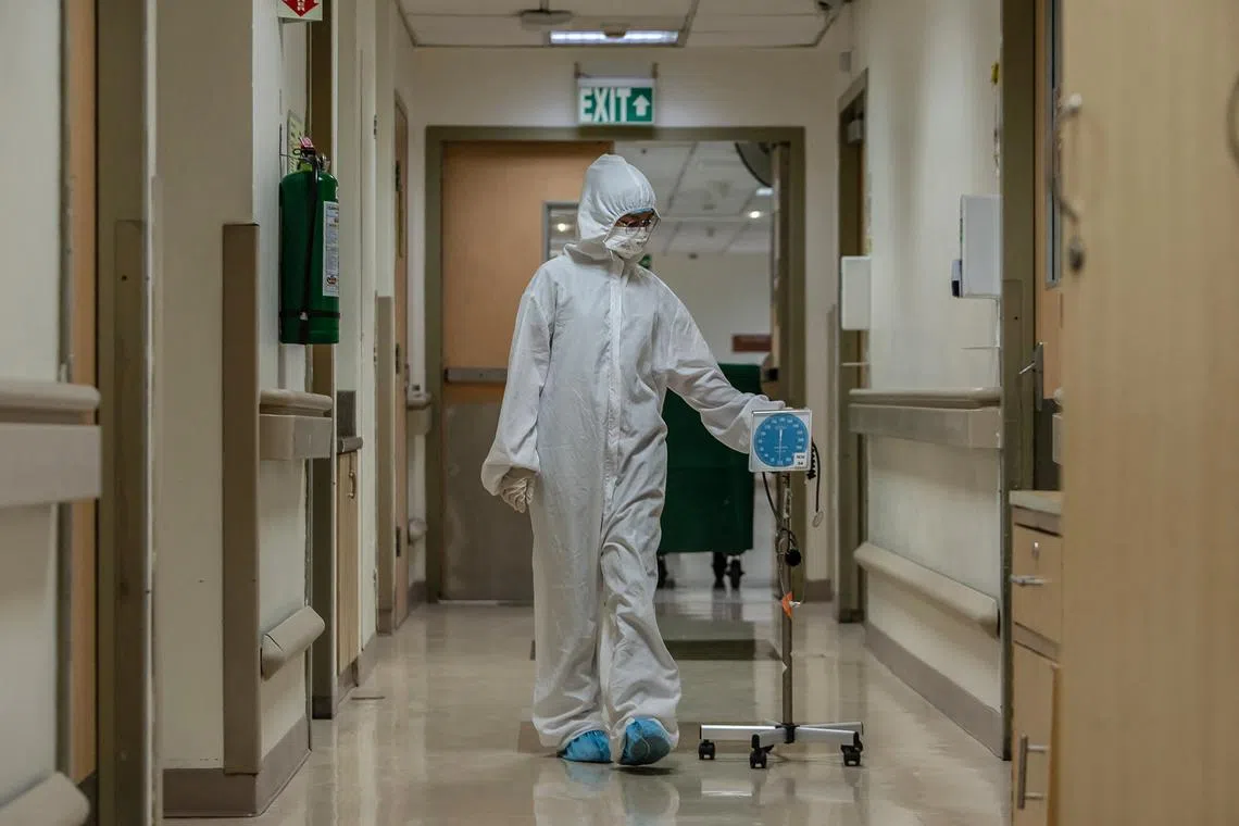 A nurse walks along a hallway before entering an intensive care unit for Covid-19 patients at a hospital in Manila on Sept 16, 2022.