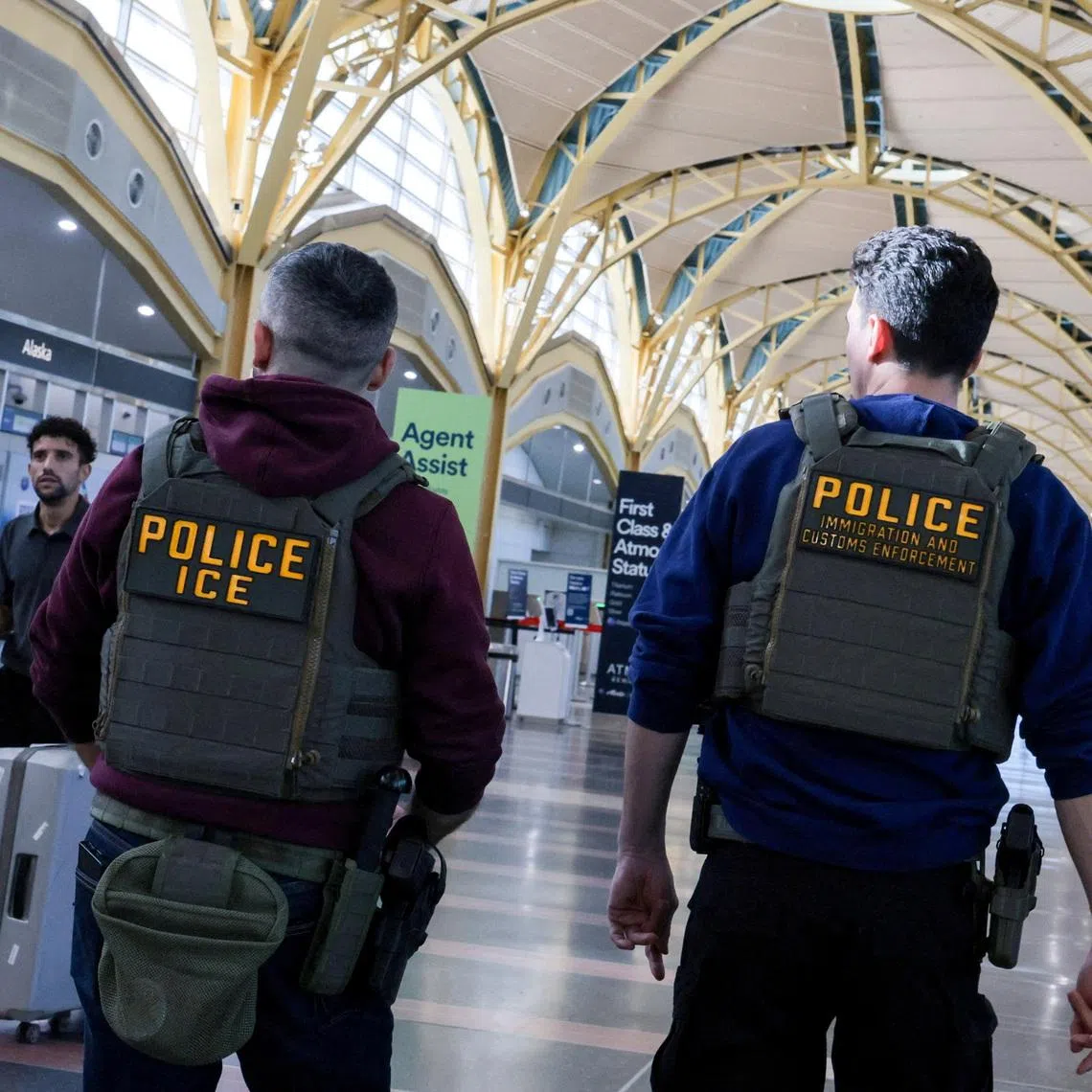 FILE PHOTO: U.S. Immigration and Customs Enforcement (ICE) agents patrol at Washington Reagan National Airport in Arlington, Virginia, U.S., March 24, 2026. REUTERS/Jonathan Ernst/File Photo