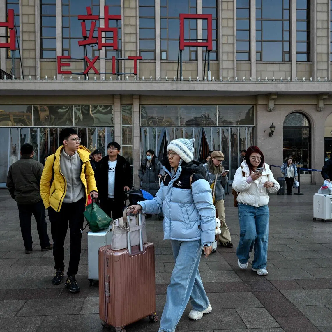 People arrive from their hometown after the spring festival holidays at the Beijing station in Beijing on Feb 24, 2026.