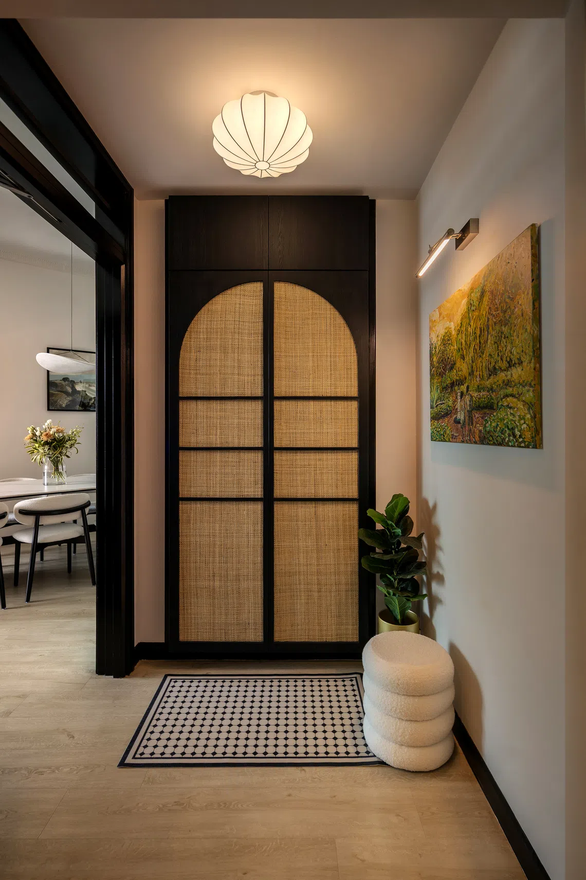 The foyer makes a strong first impression with arched rattan doors.