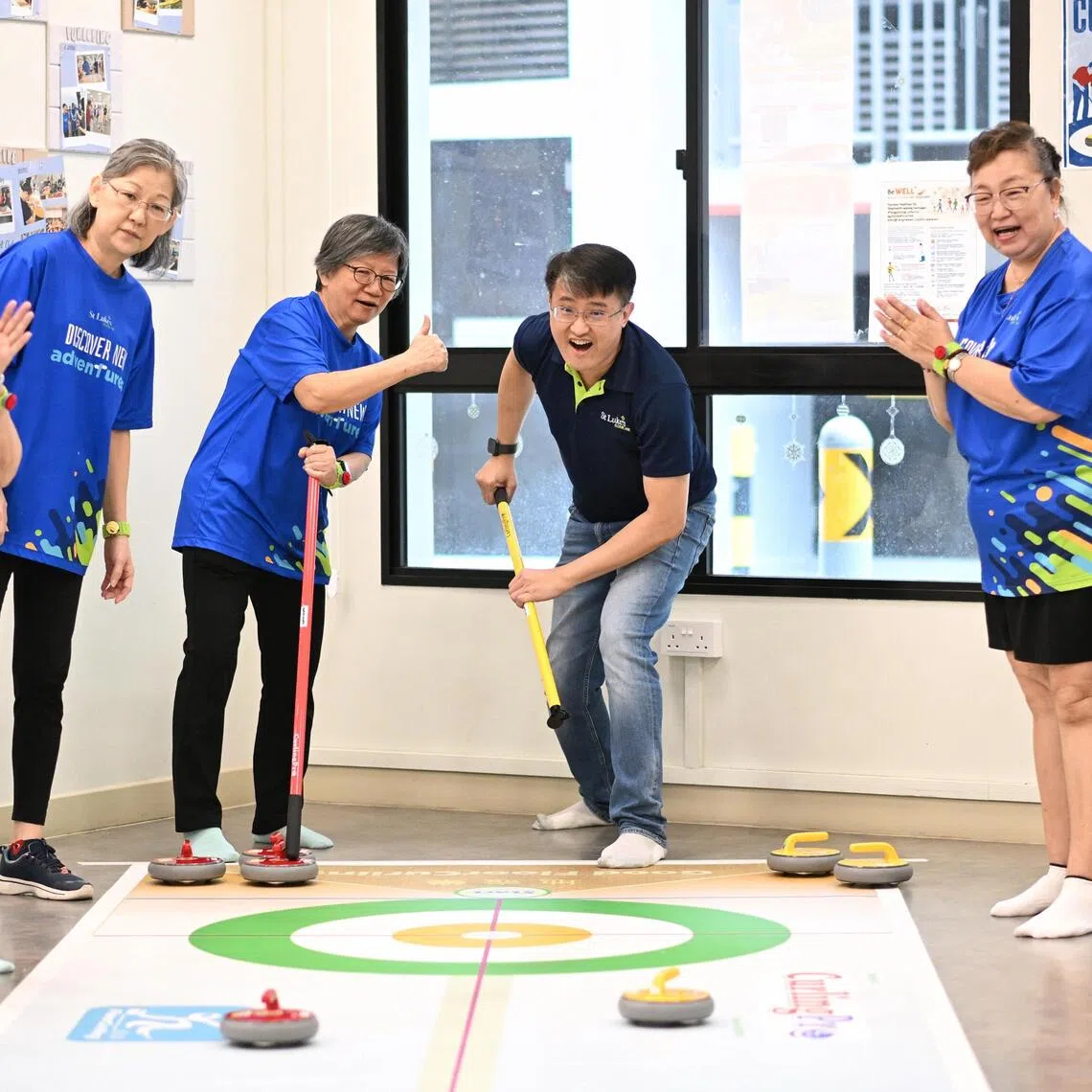 St Luke’s ElderCare CEO Kenny Tan joining seniors for a game of curling at SLEC's Active Ageing Centre (Care) at Northshore on Sept 12.