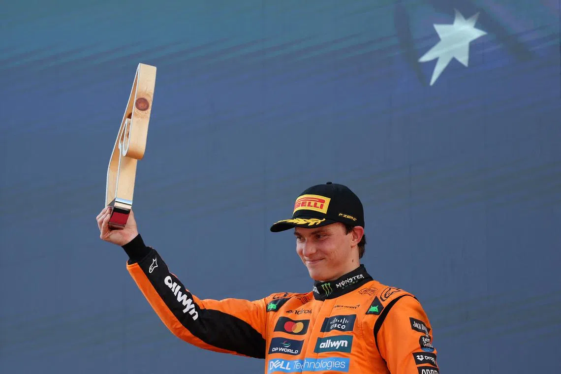Formula One F1 - Austrian Grand Prix - Red Bull Ring, Spielberg, Austria - June 29, 2025 McLaren's Oscar Piastri celebrates with a trophy on the podium after finishing second in the Austrian Grand Prix REUTERS/Gintare Karpaviciute