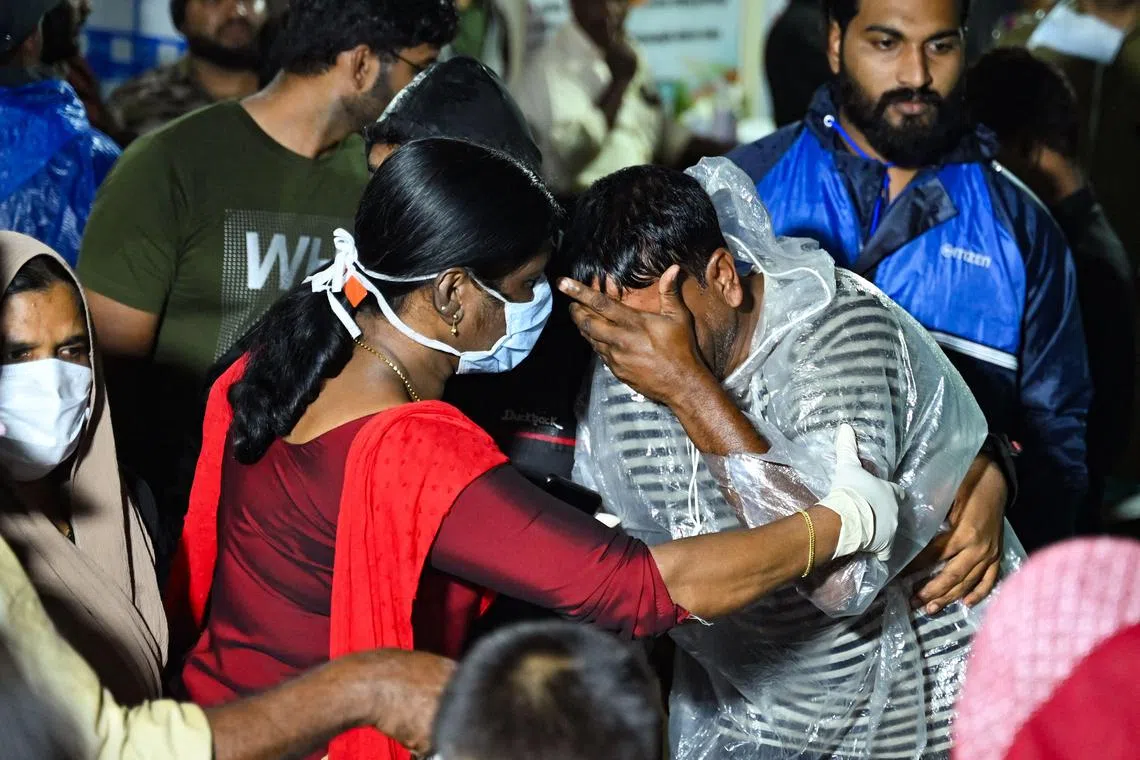 Survivors of a series of landslides on July 30 in southern India weep as they mourn their loss.