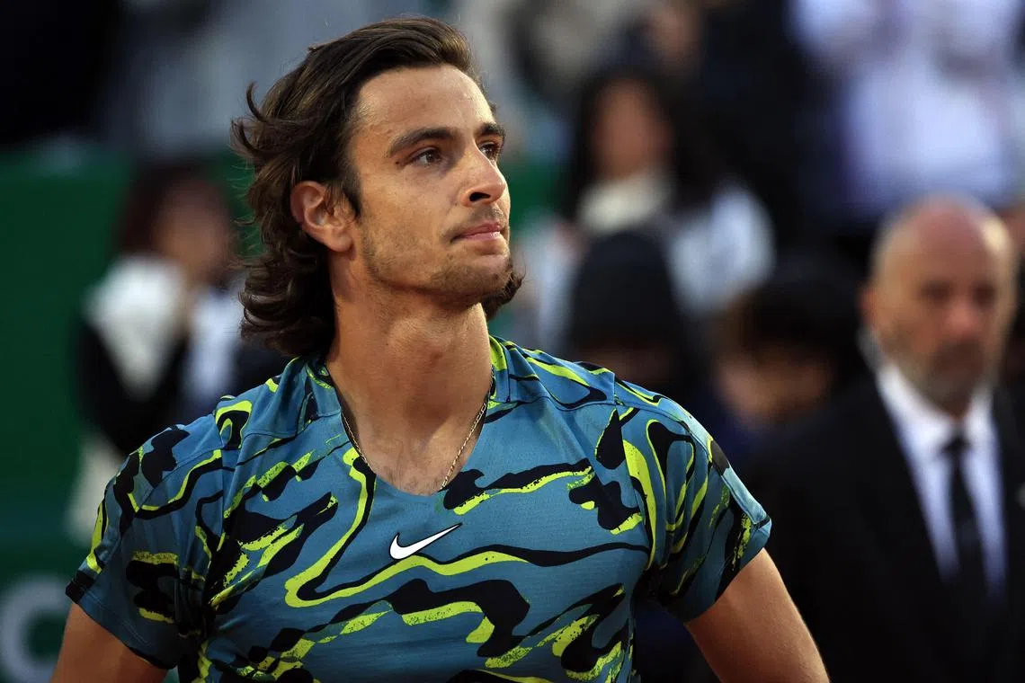 Italy's Lorenzo Musetti reacts after beating Serbia's Novak Djokovic.