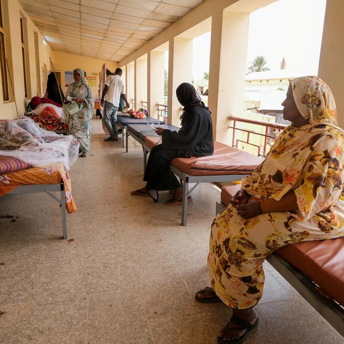 FILE PHOTO: Sudanese women sit on beds while monitoring their family members treated for dengue fever at Omdurman Hospital, as Sudan grapples with outbreaks of dengue and cholera amid the annual rainy season and a collapsed healthcare and infrastructure system, in Khartoum, Sudan, September 23, 2025. REUTERS/El Tayeb Siddig/File Photo