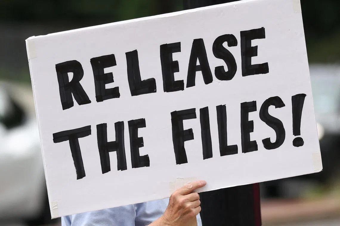 A protester calling for a release of the Epstein files holds a sign in Washington, DC on Aug 6.