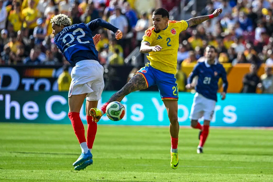 Mar 29, 2026; Landover, Maryland, USA;  Columbia defender Daniel Mu–oz (2) plays the ball past France forward Hugo Ekitike (22) during the second half at Northwest Stadium. Mandatory Credit: Tommy Gilligan-Imagn Images