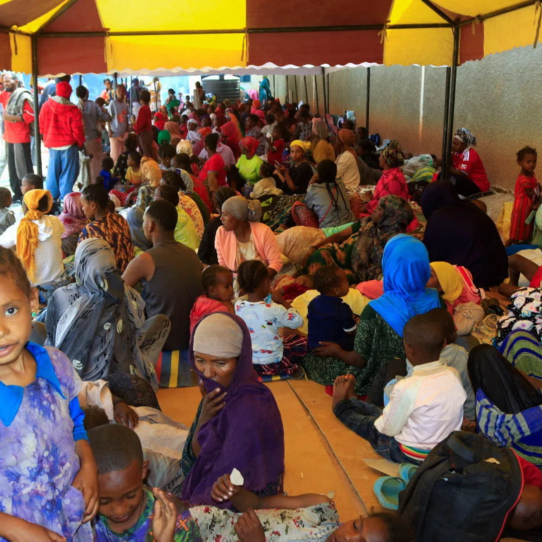 Ethiopians sit at a holding ground after fights erupted in the Ethiopian border town of Moyale, Kenya, October 23, 2026. REUTERS/REUTERS/Adduba Hussein
