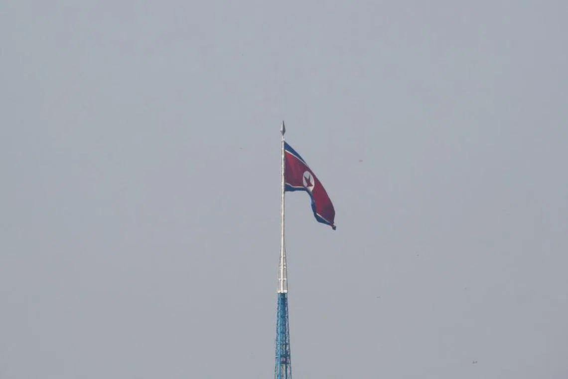 FILE PHOTO: A North Korean flag flutters on top of the 160-metre tall tower at North Korea's propaganda village of Gijungdong, in this picture taken from Tae Sung freedom village near the Military Demarcation Line (MDL), inside the demilitarised zone separating the two Koreas, in Paju, South Korea, September 30, 2019. REUTERS/Kim Hong-Ji/File Photo