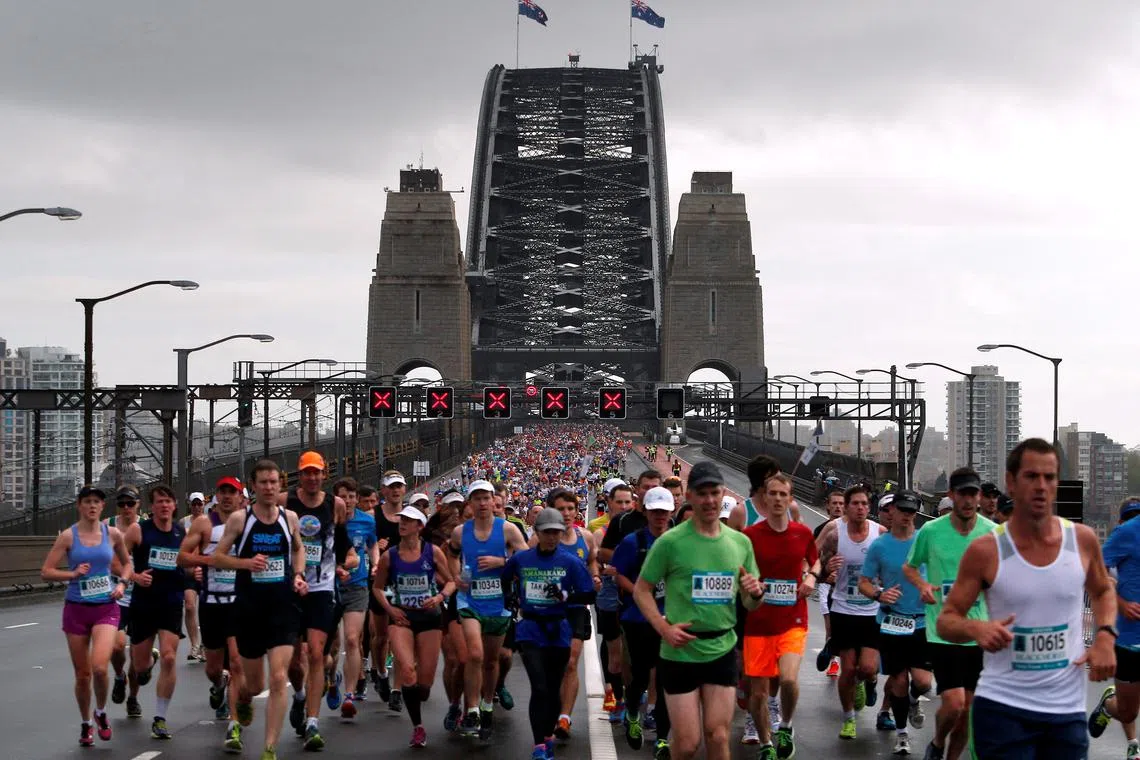 FILE PHOTO: Competitors run across the Sydney Harbour Bridge during the Sydney marathon September 21, 2014. REUTERS/David Gray/File Photo