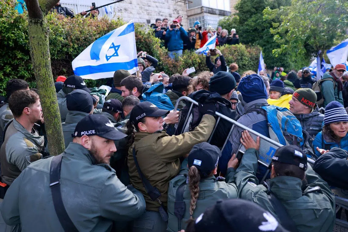 Police and protesters scuffling in front of Prime Minister Benjamin Netanyahu's Jerusalem home on March 20, during a demonstration calling for an end to the war in Gaza.