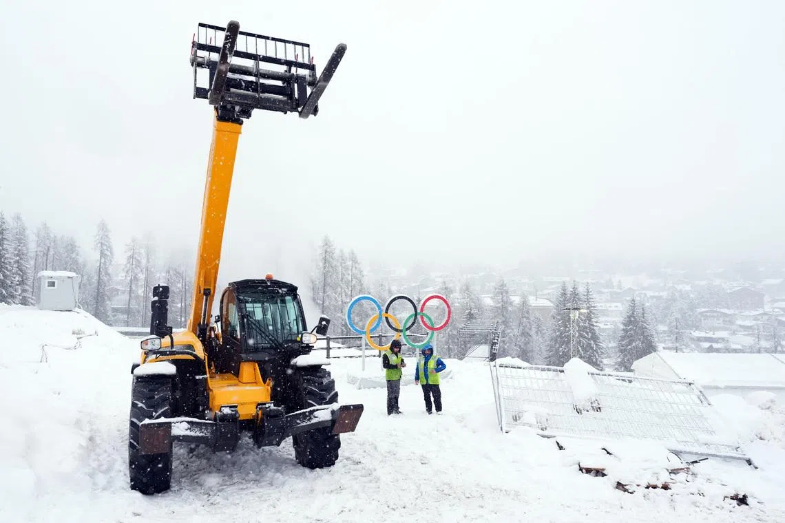 Feb 4, 2026; Cortina d'Ampezzo, ITALY; Construction crews work ahead of the Milano Cortina 2026 Olympic Winter Games at the Cortina Sliding Centre. Mandatory Credit: Eric Bolte-Imagn Images