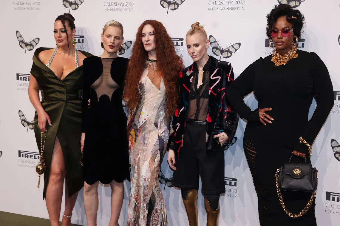 From left: Ashley Graham, Guinevere Van Seenus, Emma Summerton, Lauren Wasser and Precious Lee pose as they arrive at Bicocca's Hangar for the presentation of Pirelli's calendar 2023 in Milan, Italy on Nov 16, 2022.  