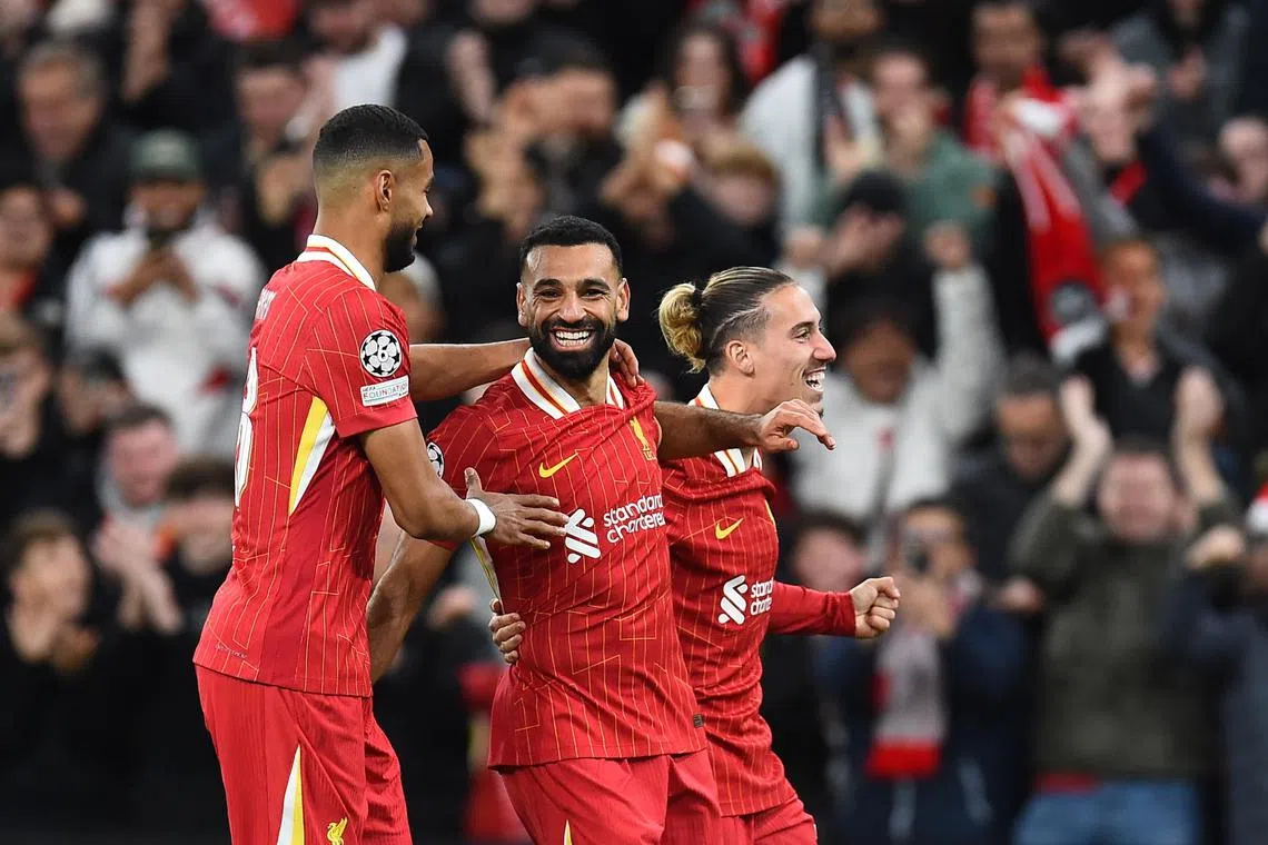 Liverpool's Mohamed Salah celebrates with teammates after scoring the second goal in the 2-0 win over Bologna in the Champions League.