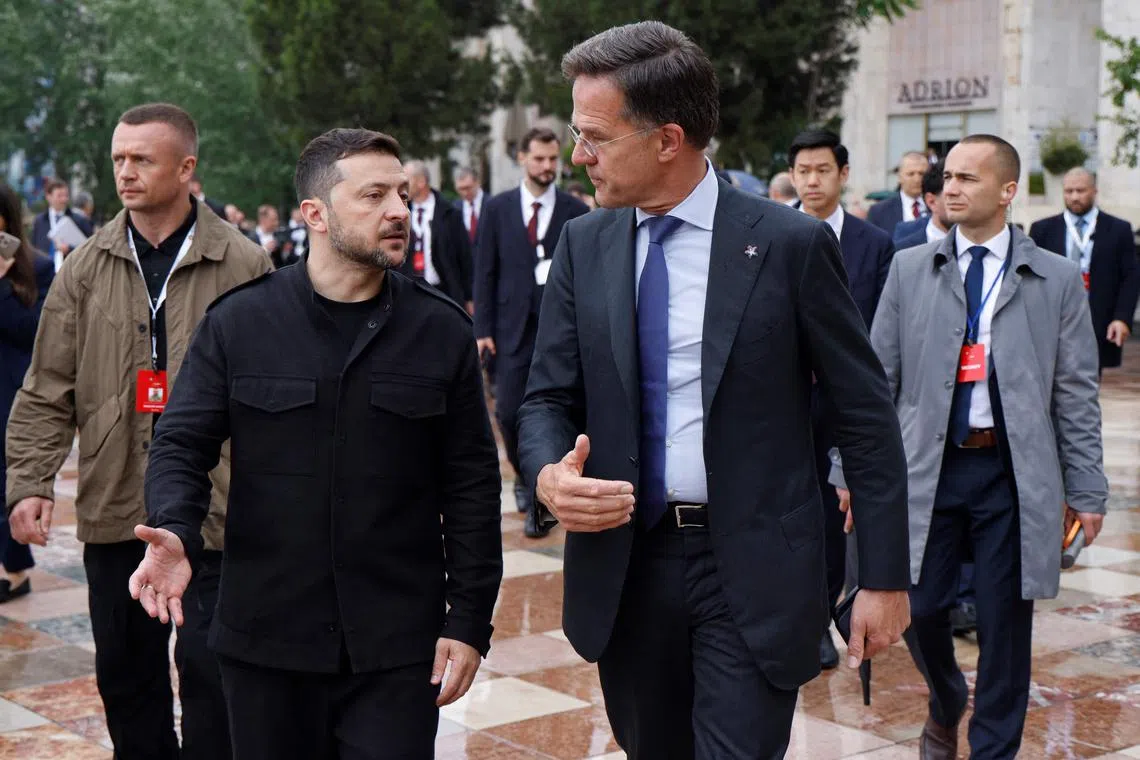 Ukraine's President Volodymyr Zelenskyy (L) speaks with NATO Secretary General Mark Rutte during the European Political Community (EPC) summit, in Tirana on May 16, 2025. (Photo by Ludovic MARIN / AFP)