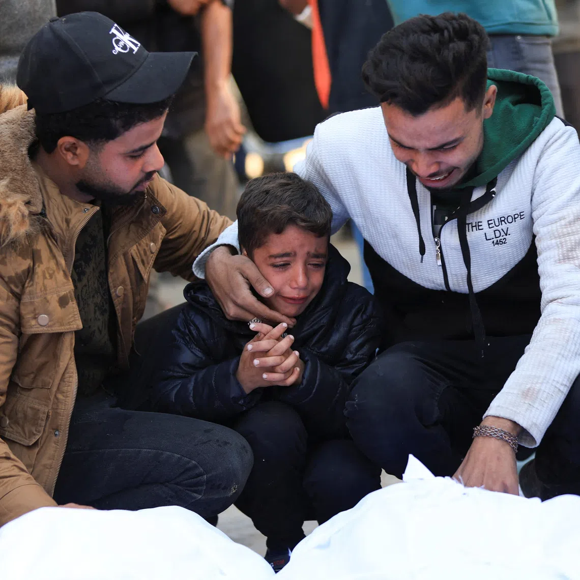 Mourners react as they attend the funeral of Palestinians who, according to medics, were killed in an Israeli strike on Tuesday, at Al-Shifa Hospital in Gaza City, December 3, 2025. REUTERS/Dawoud Abu Alkas