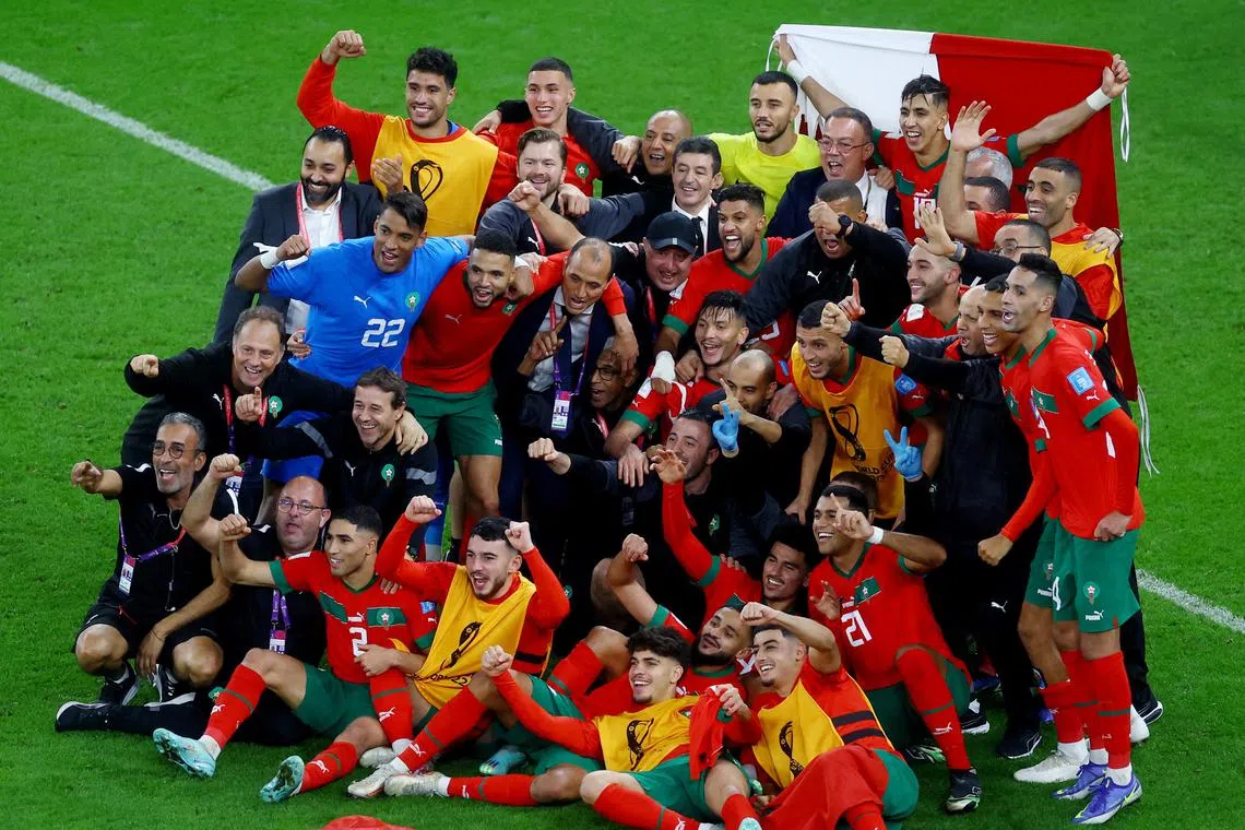 Morocco players and staff posing for a photo after their World Cup quarter-final win over Portugal on Saturday (Dec 10, 2022).