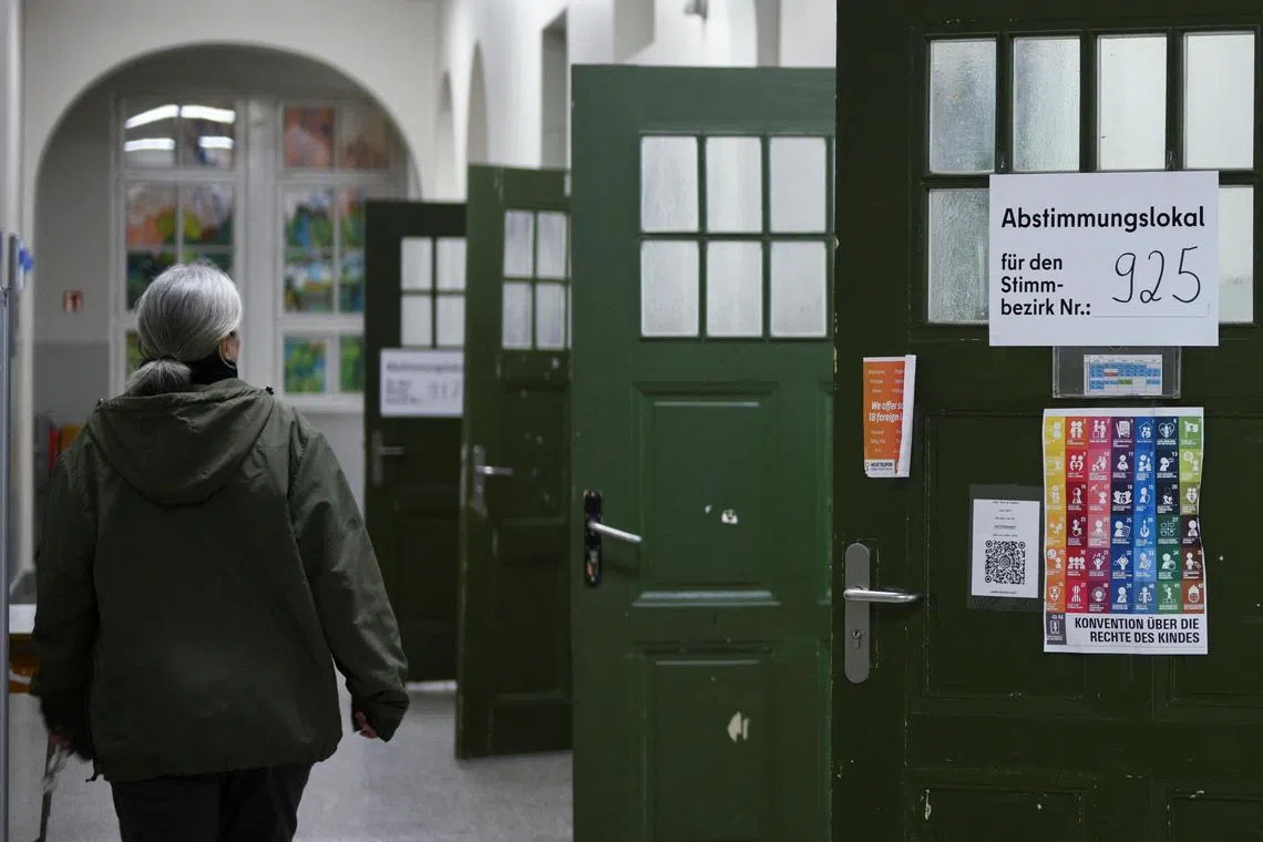 A woman walks at a polling station during the "Berlin 2030 Climate Neutral" referendum in Berlin, Germany March 26, 2023. REUTERS/Annegret Hilse