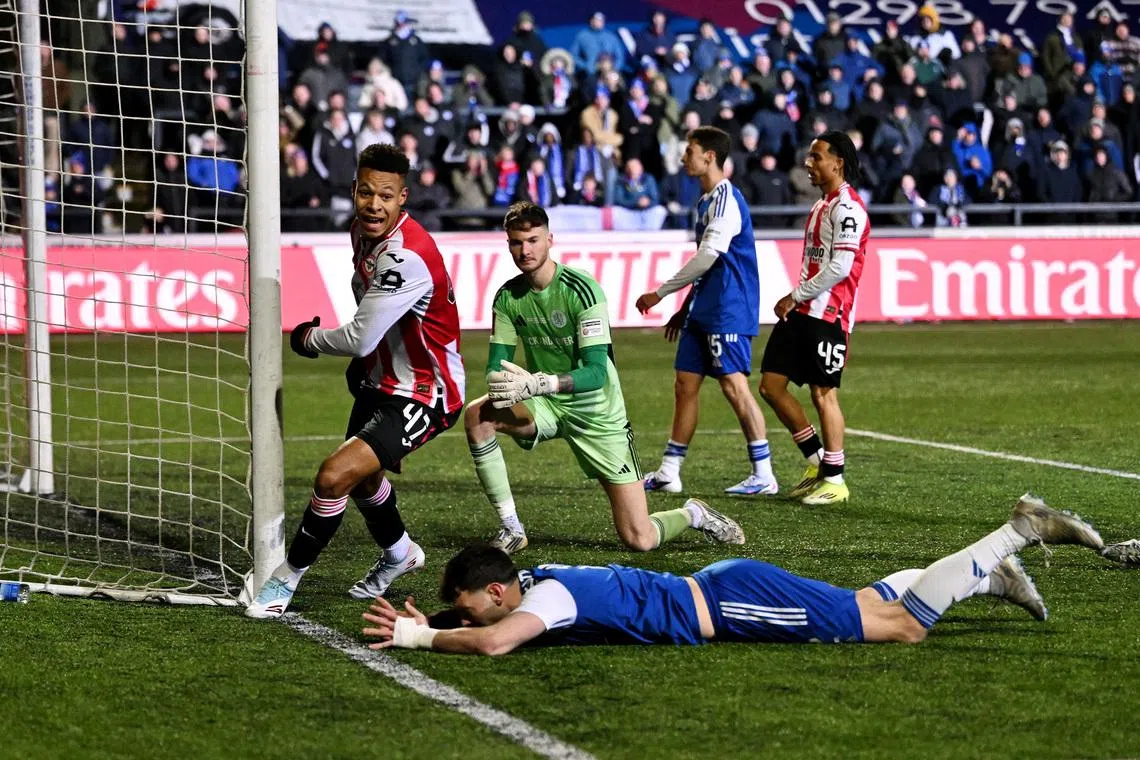 Soccer Football -  FA Cup - Fourth Round - Macclesfield Town v Brentford - Moss Rose, Macclesfield, Britain - February 16, 2026 Brentford's Kaye Furo celebrates after Macclesfield Town's Sam Heathcote scores an own goal and Brentford's first REUTERS/Peter Powell