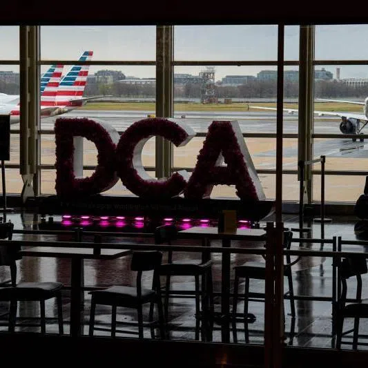 Passengers stand in one of the terminals as multiple flights have been cancelled and delayed at Ronald Reagan Washington National Airport on March 16 in Arlington, Virginia.