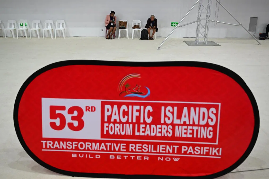 Delegates sit behind the logo ahead of the plenary session at the 53rd Pacific Islands Forum Leaders Meeting in Nuku'alofa, Tonga, on Aug 28.