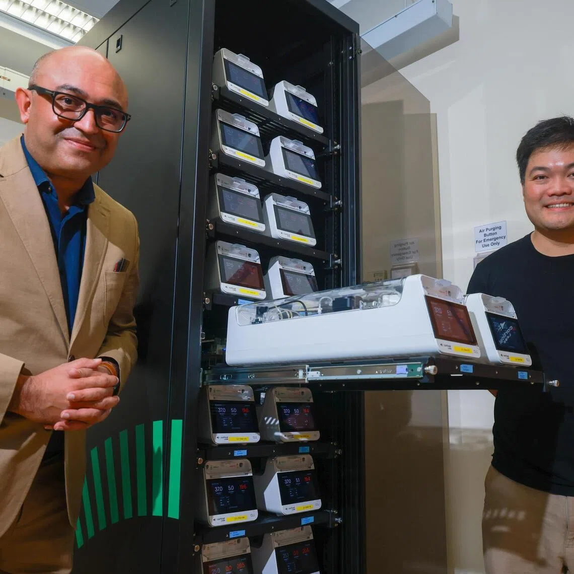 Prof Rickie Patani (left) and Hon Weng Chong, Founder and CEO of Cortical Labs, at the brain-cell powered data centre at NUS on Aug 7.
