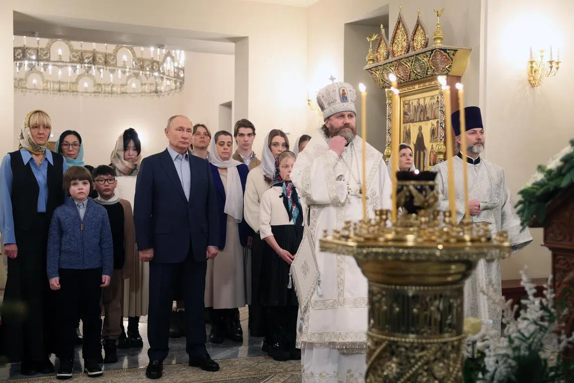 Russian President Vladimir Putin (centre) attending a Christmas service at the Church of the Holy Image of the Savior Not Made by Hands on Jan 6.